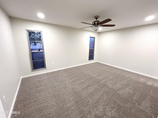 unfurnished room with ceiling fan and carpet floors