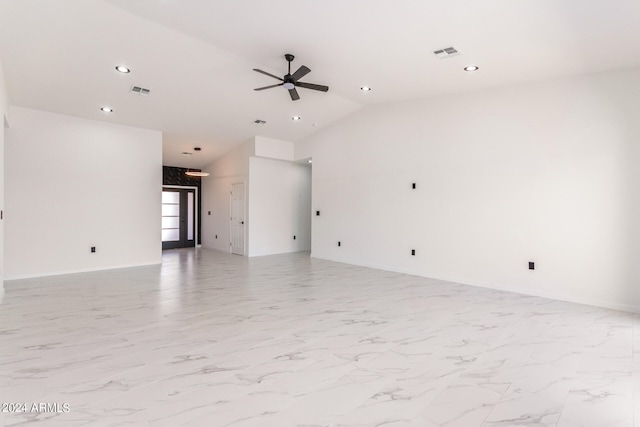 empty room featuring ceiling fan, vaulted ceiling, and light tile patterned floors