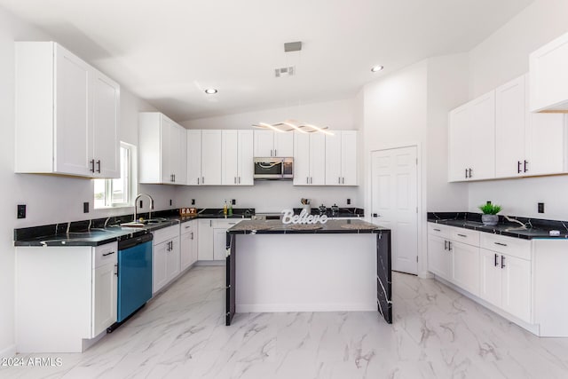 kitchen with white cabinets, vaulted ceiling, light tile patterned floors, a center island, and stainless steel appliances