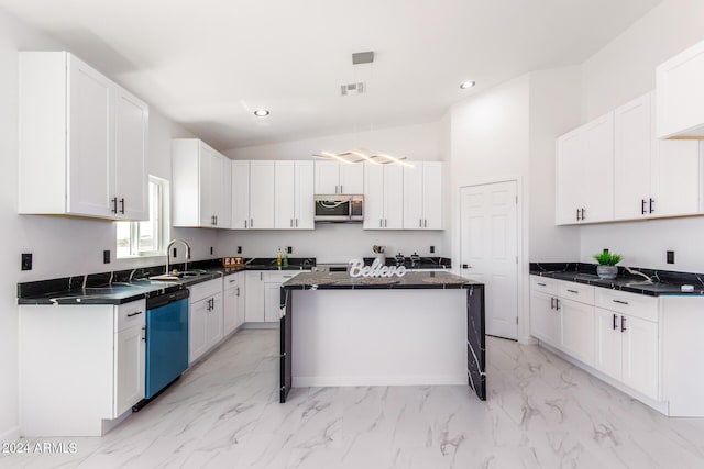 kitchen featuring appliances with stainless steel finishes, dark countertops, white cabinetry, and a kitchen island