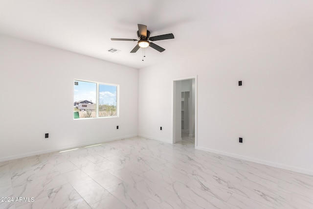 tiled empty room with ceiling fan