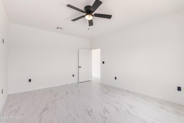 spare room featuring ceiling fan and light tile patterned floors