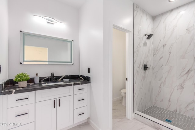 bathroom featuring tile patterned flooring, toilet, a tile shower, and vanity