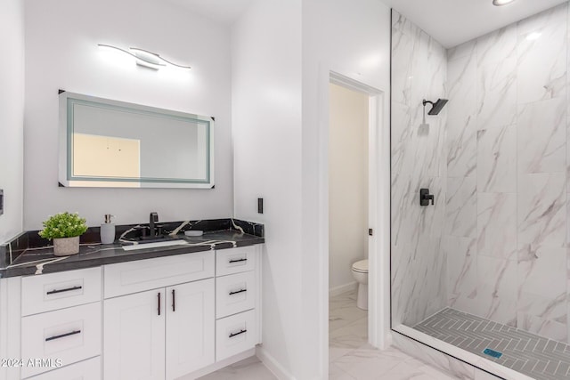 full bath featuring a marble finish shower, baseboards, toilet, marble finish floor, and vanity