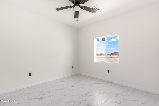 unfurnished room featuring marble finish floor, ceiling fan, visible vents, and baseboards