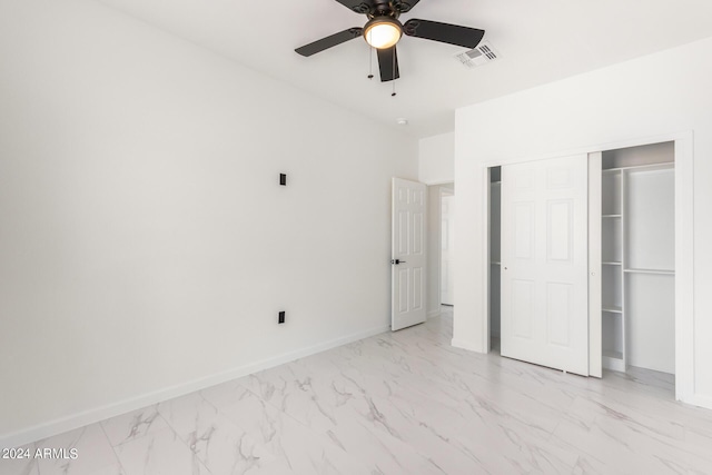 unfurnished bedroom with ceiling fan, visible vents, baseboards, marble finish floor, and a closet