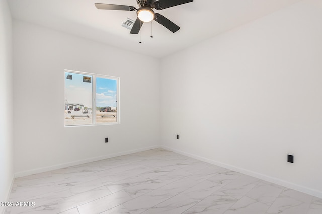 tiled spare room with ceiling fan