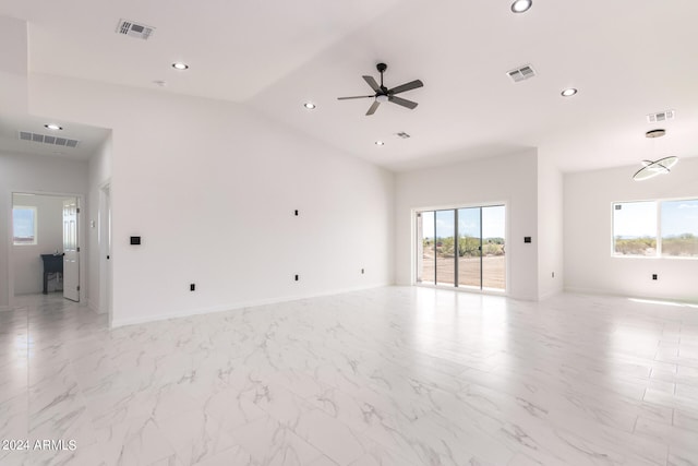 tiled empty room with high vaulted ceiling and ceiling fan