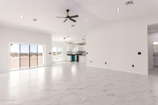 unfurnished living room with ceiling fan, lofted ceiling, and light tile patterned floors