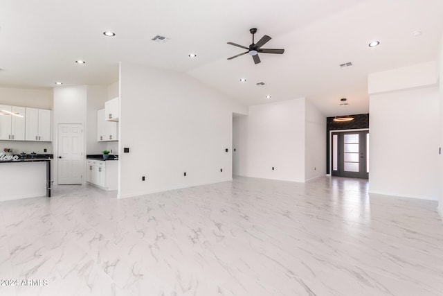 unfurnished living room featuring light tile patterned floors, vaulted ceiling, and ceiling fan