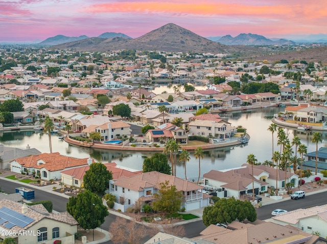 aerial view at dusk with a water and mountain view