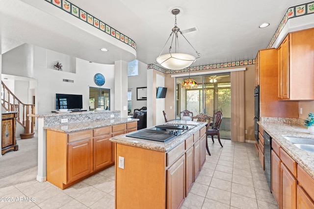 kitchen with light tile patterned flooring, a kitchen island, pendant lighting, black electric stovetop, and light stone countertops