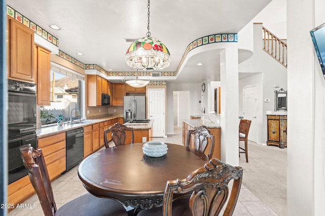 tiled dining area with an inviting chandelier and sink