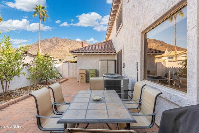 view of patio / terrace with a mountain view and central AC