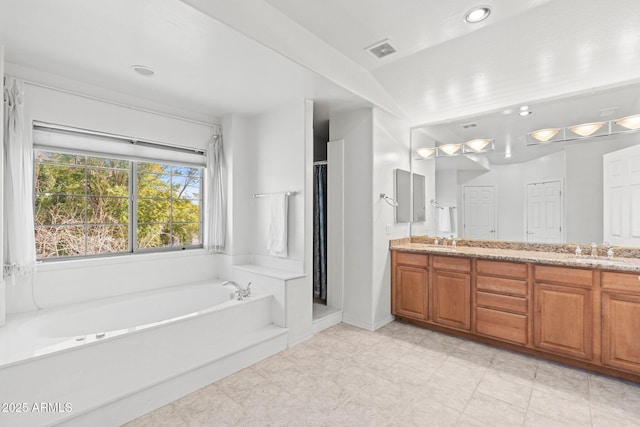 bathroom featuring vanity and plus walk in shower