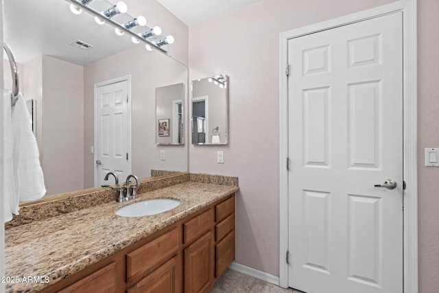 bathroom with tile patterned floors and vanity