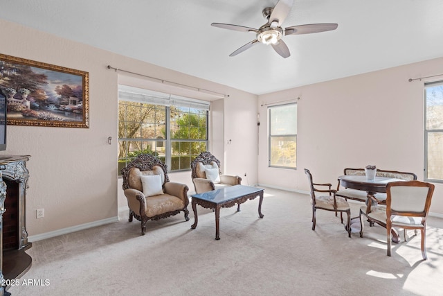 interior space featuring light carpet and ceiling fan