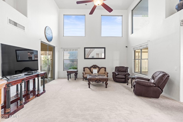 living room featuring carpet floors and ceiling fan