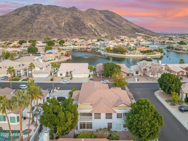 aerial view at dusk with a water and mountain view