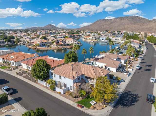 drone / aerial view with a water and mountain view