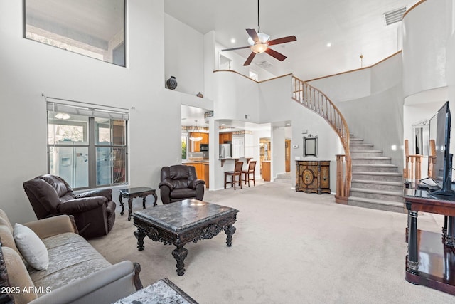 carpeted living room with ceiling fan