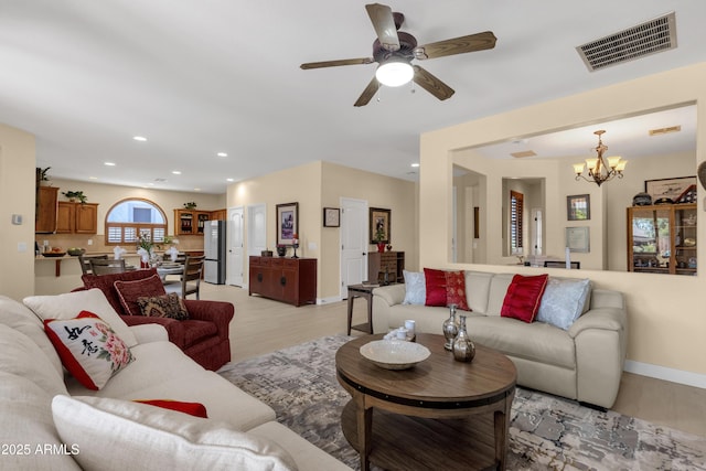 living room featuring recessed lighting, baseboards, visible vents, light wood-type flooring, and ceiling fan with notable chandelier