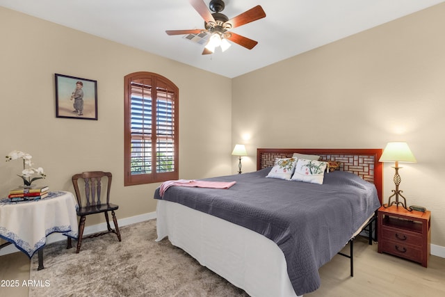 bedroom with ceiling fan and baseboards