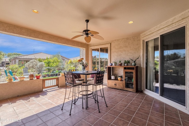 view of patio featuring a ceiling fan and outdoor dining area