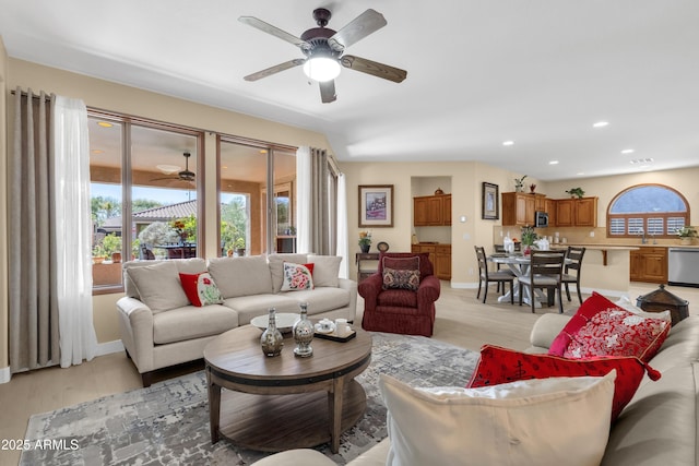 living room featuring recessed lighting, light wood-style flooring, and a healthy amount of sunlight