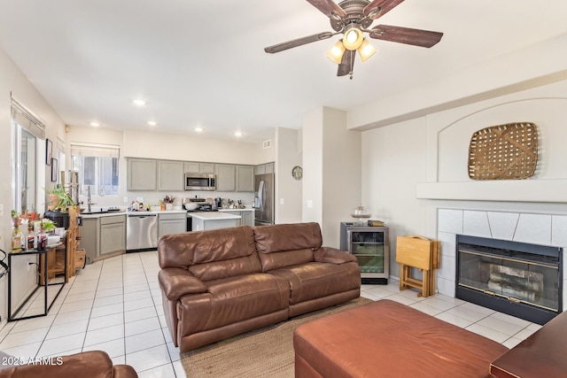 1451 E S Fork Dr, Phoenix, AZ 85048 - living area featuring beverage cooler, light tile patterned flooring, a ceiling fan, a fireplace, and recessed lighting