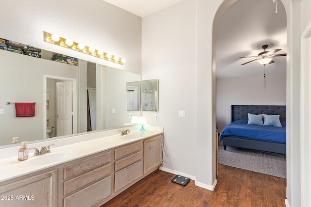 1451 E S Fork Dr, Phoenix, AZ 85048 - full bathroom with wood finished floors, double vanity, toilet, ceiling fan, and connected bathroom