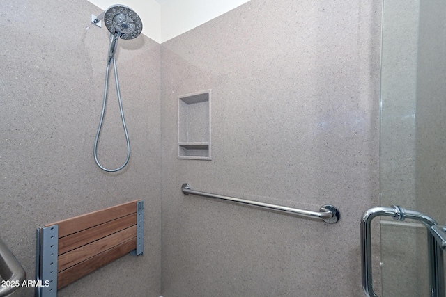 bathroom with a shower with door