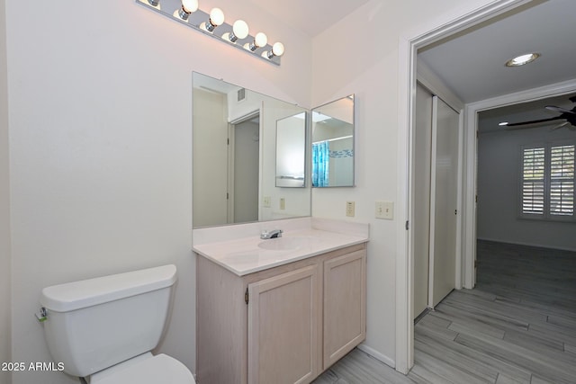 bathroom with vanity, ceiling fan, toilet, and wood-type flooring