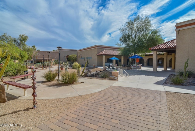 view of home's community with a patio area