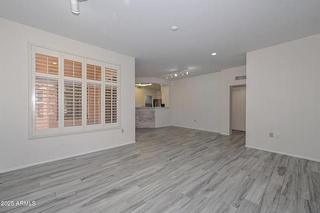 unfurnished living room with light hardwood / wood-style floors