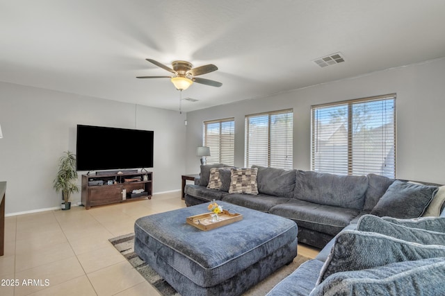 living room featuring baseboards, a ceiling fan, visible vents, and light tile patterned floors