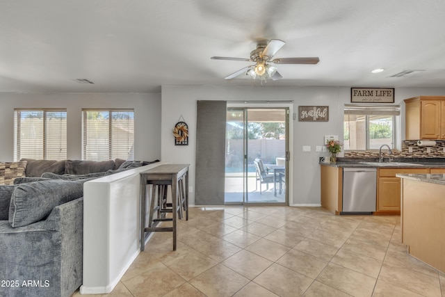 kitchen with open floor plan, a healthy amount of sunlight, visible vents, dishwasher, and a ceiling fan