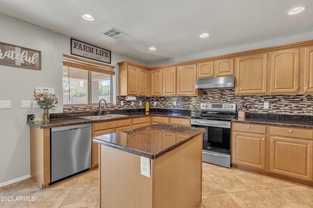 kitchen with visible vents, stainless steel appliances, tasteful backsplash, under cabinet range hood, and a sink