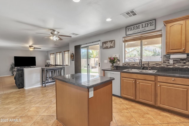 kitchen featuring a center island, a sink, visible vents, dishwasher, and a ceiling fan