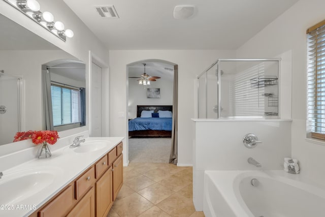 ensuite bathroom featuring visible vents, an enclosed shower, a sink, and a ceiling fan