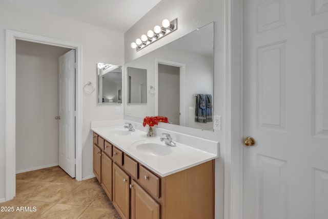bathroom featuring double vanity, a sink, and tile patterned flooring