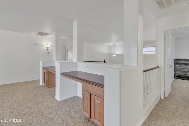 kitchen featuring visible vents and light colored carpet