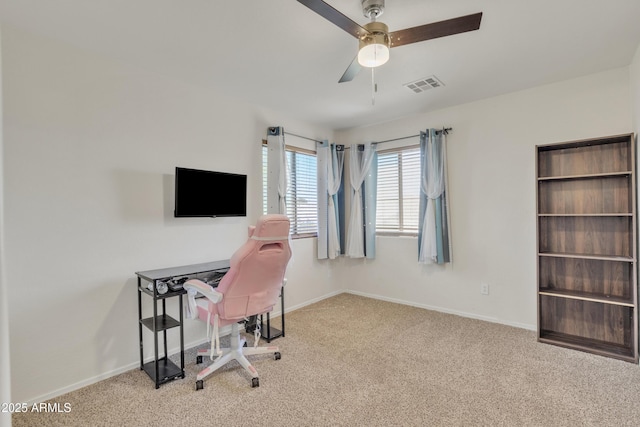 carpeted office with a ceiling fan, baseboards, and visible vents