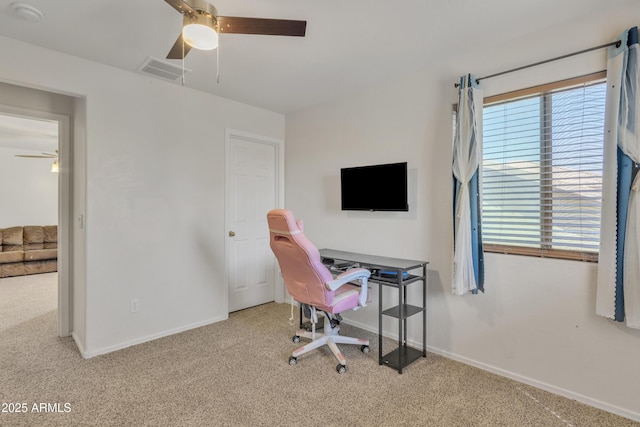 carpeted office featuring plenty of natural light, visible vents, and ceiling fan