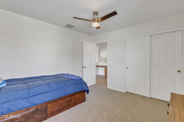 carpeted bedroom with baseboards, visible vents, a closet, and a ceiling fan