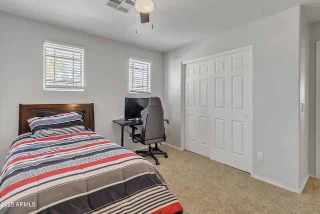 carpeted bedroom with a ceiling fan, baseboards, a closet, and visible vents