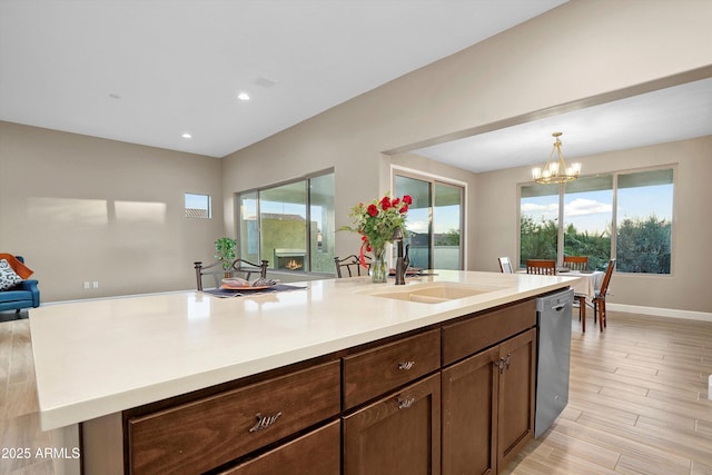 32128 S Bighorn Dr, Oracle, AZ 85623 - kitchen featuring stainless steel dishwasher, a chandelier, light countertops, recessed lighting, and hanging light fixtures