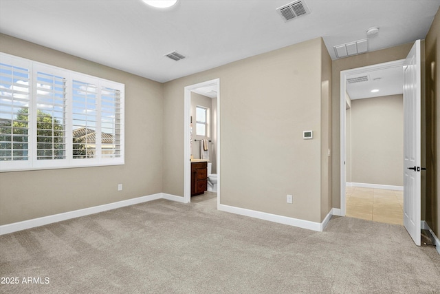 32128 S Bighorn Dr, Oracle, AZ 85623 - unfurnished bedroom with light carpet and connected bathroom