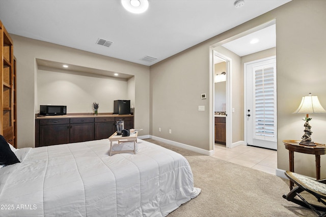 32128 S Bighorn Dr, Oracle, AZ 85623 - bedroom with light colored carpet, recessed lighting, light tile patterned floors, and ensuite bath