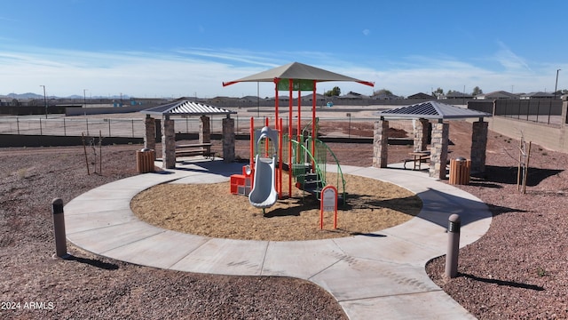 community jungle gym featuring a gazebo and fence